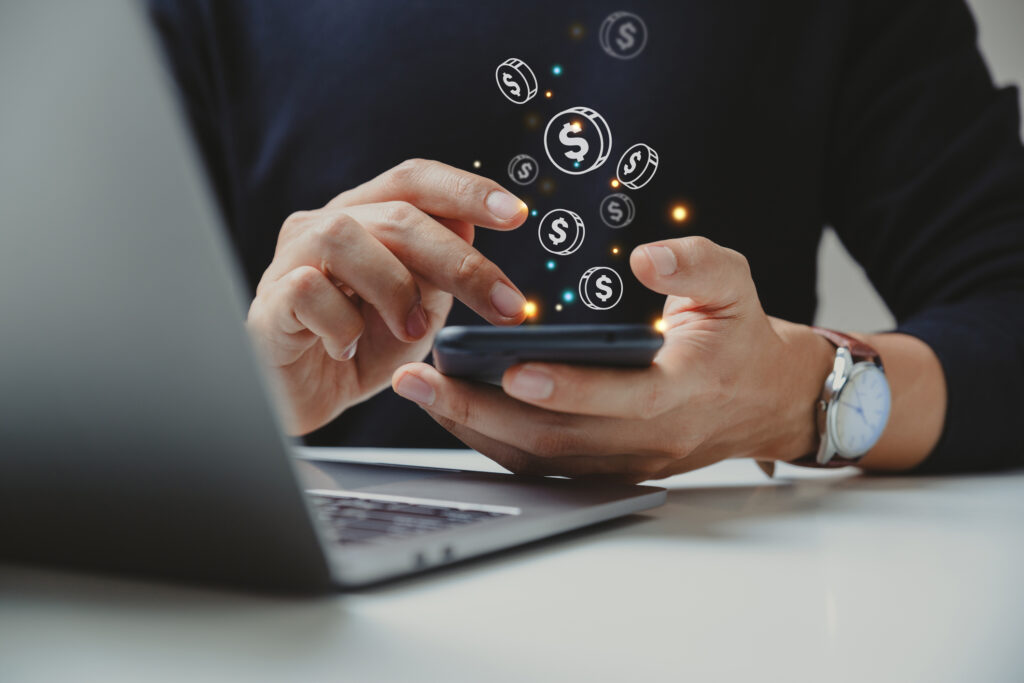 Hand of businessman using smart phone with coin icon, Online transaction, fintech business, Internet investment