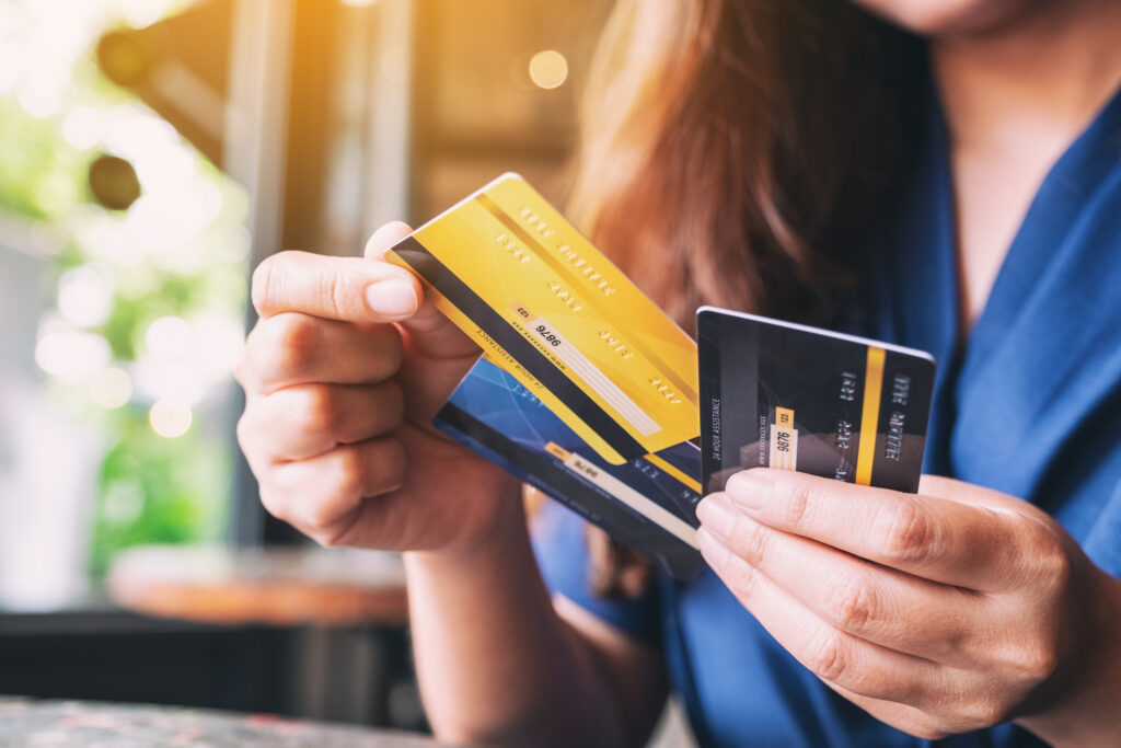 Closeup image of a woman holding and choosing credit card to use