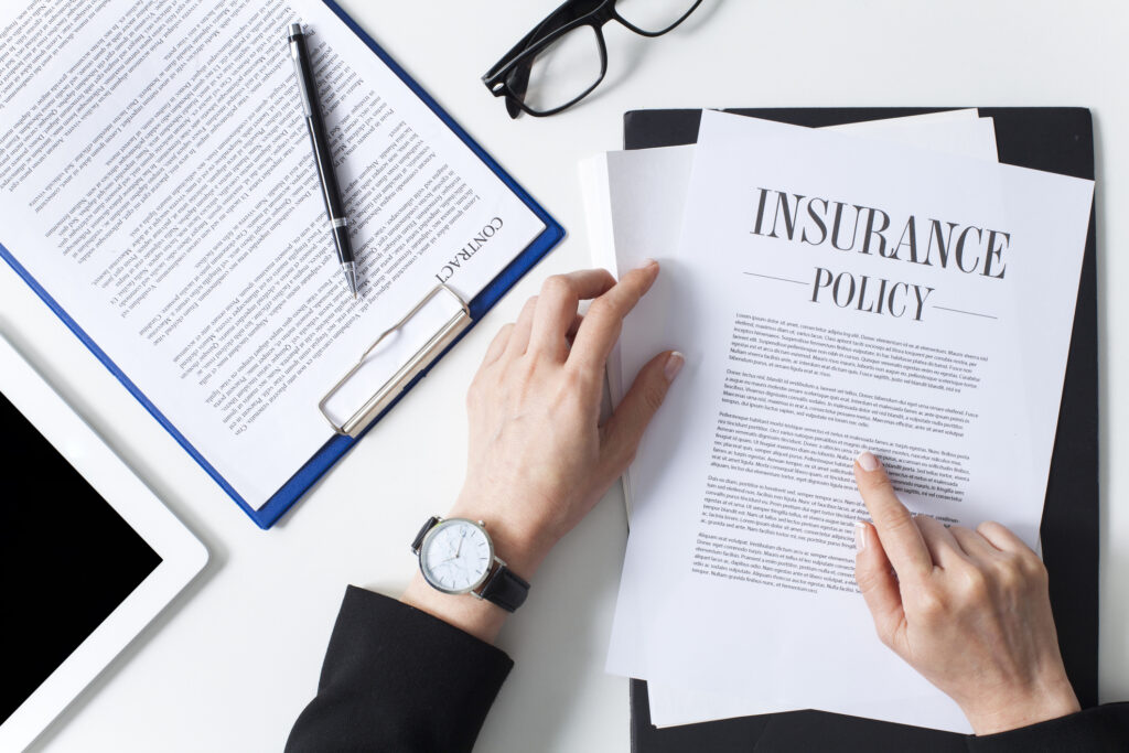 Business woman showing insurance document over white desk at office