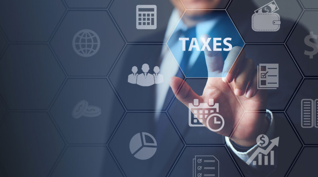 Businessman using innovative virtual touchscreen presses taxes button. tax return surrounding. taxes Concept