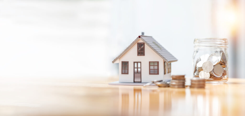 house model and money coins saving for concept saving money for home insurance.