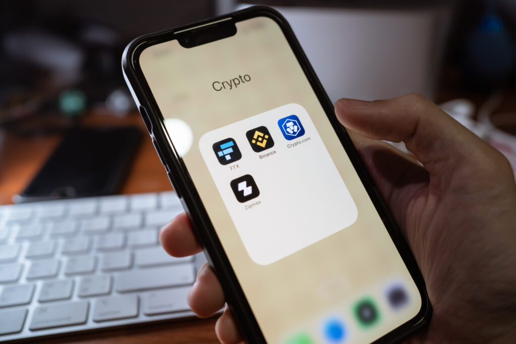 iPhone 13 showing its screen with FTX, Binance, Crypto.com, Zipmex, popular cryptocurrency trading applications.