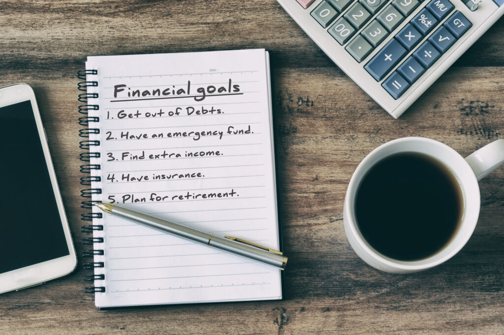 financial goals Notepad, coffee, Pen, Eyeglasses, Smart Phone