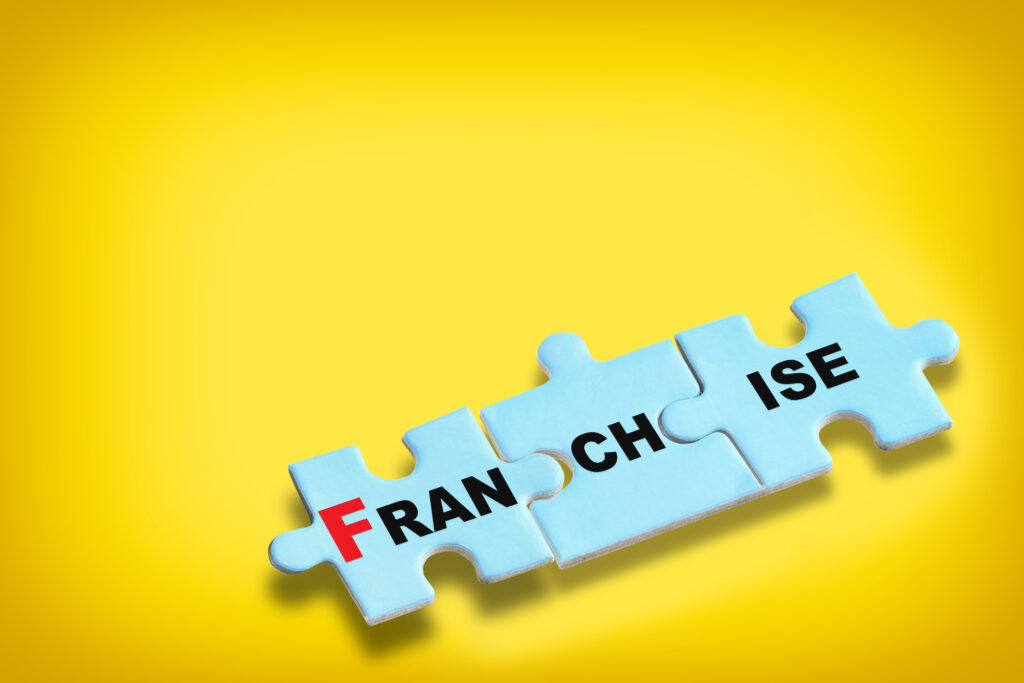 Franchise written on blue puzzle on yellow background