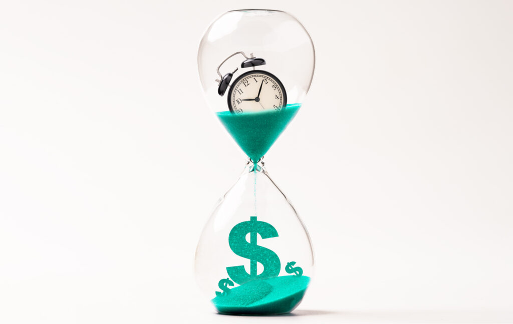 Alarm clock inside hourglass and countdown to US dollar sign, Money and time management concept.